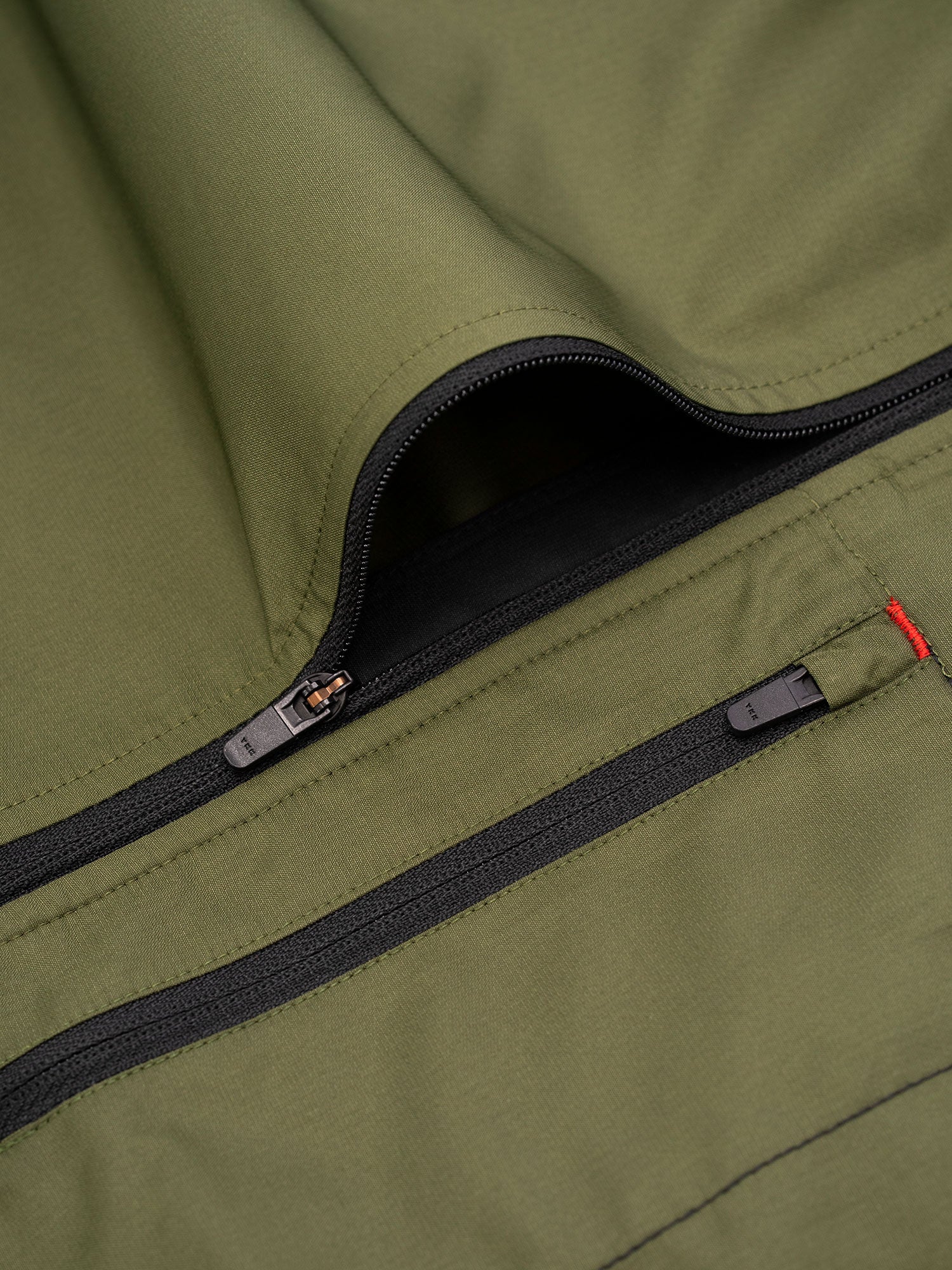 Fusion Men's S1 Run Jacket in Green pocket detail and YKK Zip